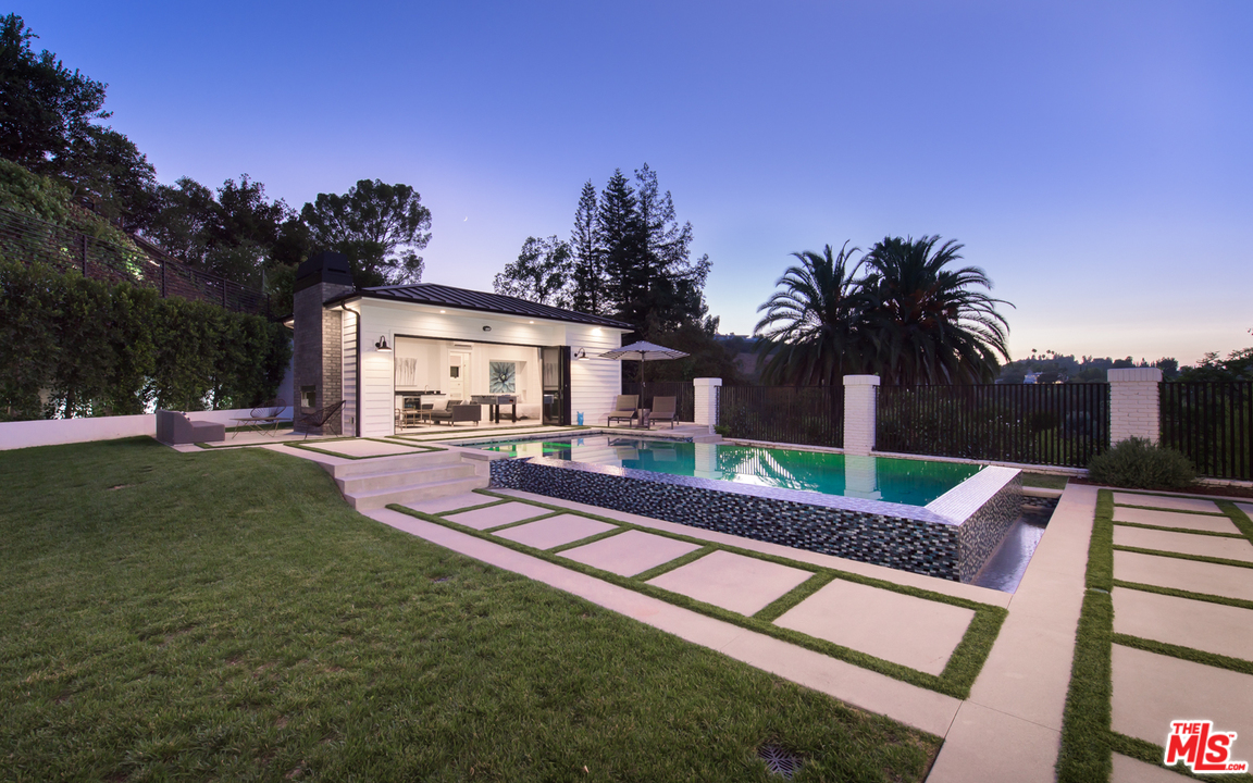 16656 Oldham Street Encino, CA 91436 - Photo 43 of 46 a front view of a house with garden