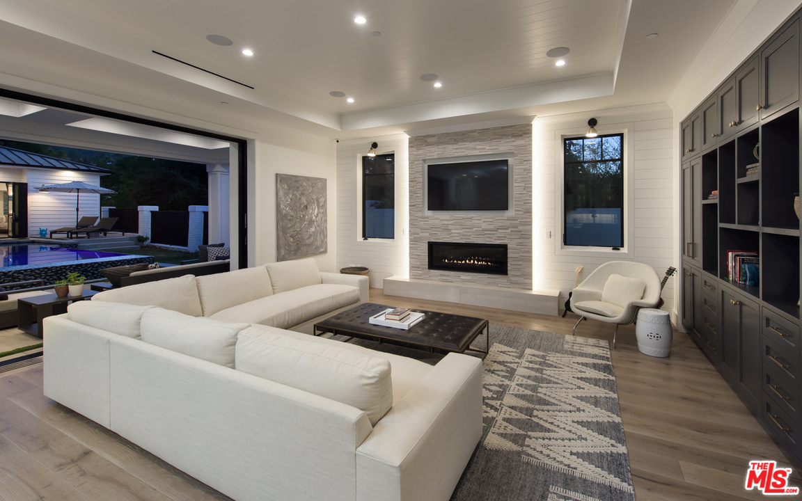 16656 Oldham Street Encino, CA 91436 - Photo 7 of 46 a living room with furniture and a fireplace