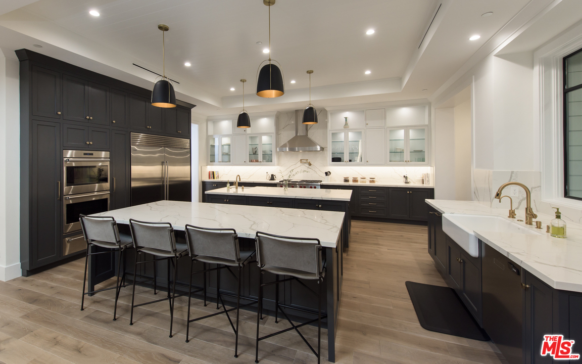 16656 Oldham Street Encino, CA 91436 - Photo 9 of 46 a large kitchen with a table and chairs