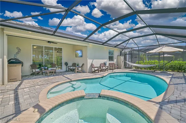 a swimming pool with outdoor seating and yard