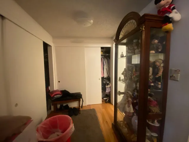 a bathroom with a granite countertop toilet sink and mirror