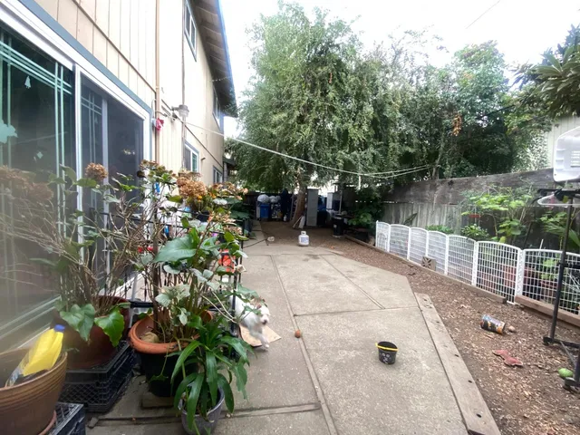 a view of a balcony with chairs and wooden fence