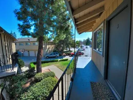 a view of a house with a street from a balcony