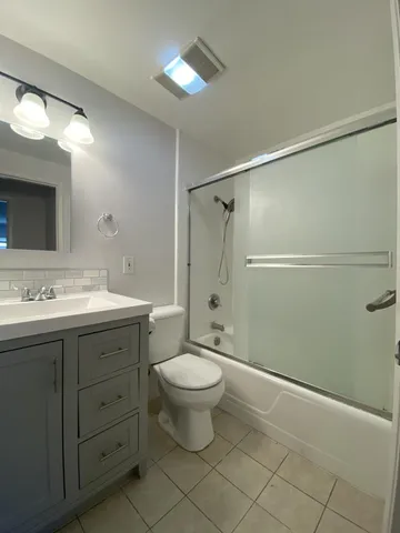 a kitchen with granite countertop sink stove and cabinets