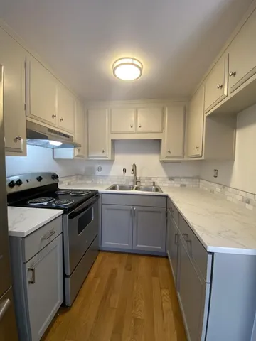 a view of a kitchen with a sink and dishwasher