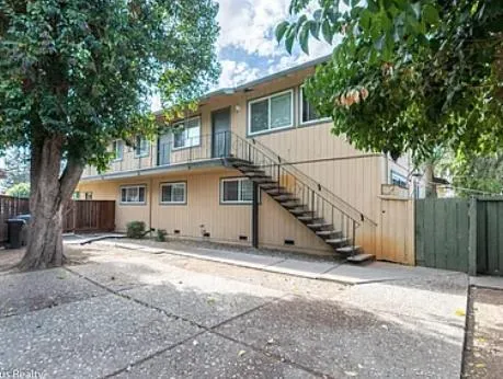 a view of a big room with wooden floor and staircase