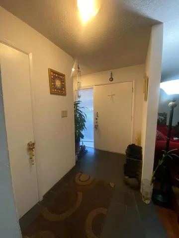 a living room with furniture chess board and a window