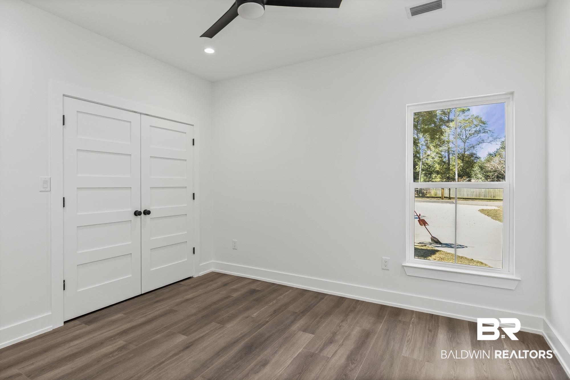10180 Pineview Drive Foley, AL 36535 - Photo 26 of 47 Unfurnished bedroom featuring dark wood finished floors, a closet, ceiling fan, and recessed lighting
