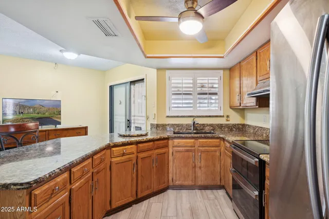 a kitchen with stainless steel appliances granite countertop a sink and stove