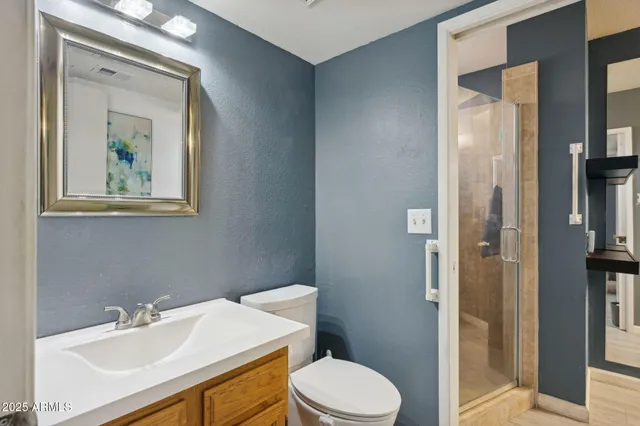 a bathroom with a toilet a sink and shower