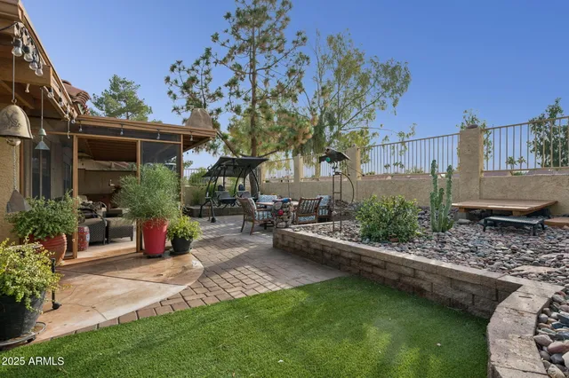 a view of backyard with outdoor seating and green space