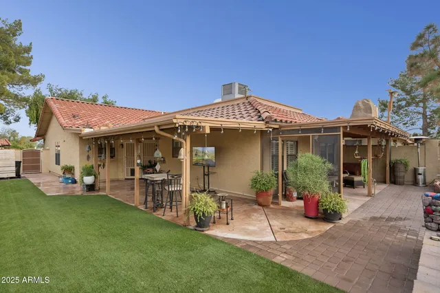 a front view of a house with a garden and patio