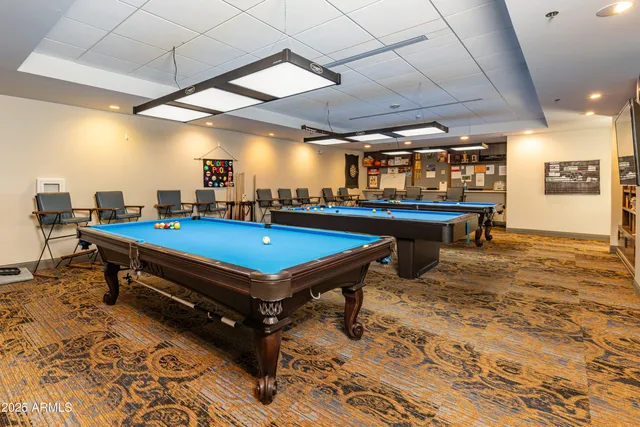 a pool table with chairs