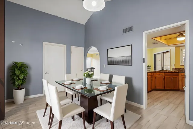 a dining room with furniture and wooden floor