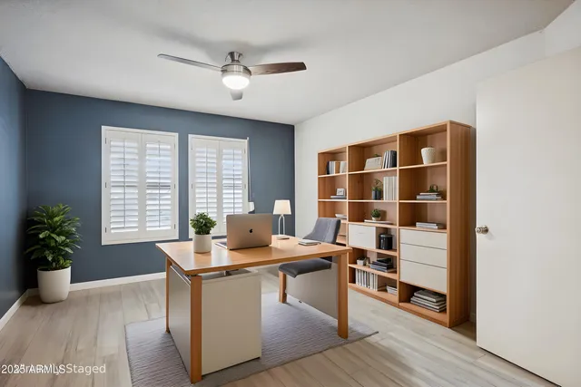 a workspace with furniture and a potted plant