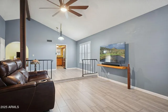 a living room with furniture and a wooden floor
