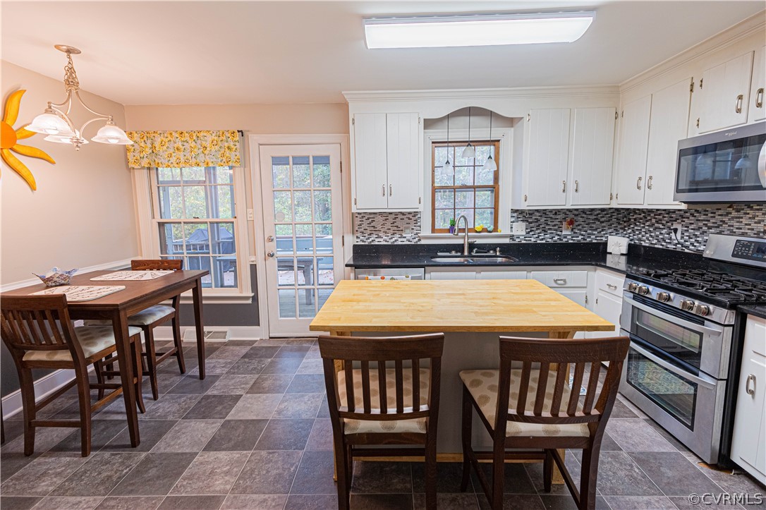 3913 Pebble Creek Road Midlothian, VA 23112 - Photo 17 of 41 a kitchen with a table chairs sink and cabinets