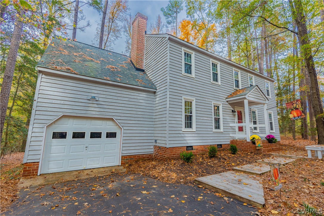 3913 Pebble Creek Road Midlothian, VA 23112 - Photo 5 of 41 a view of a house with a small yard and a large tree