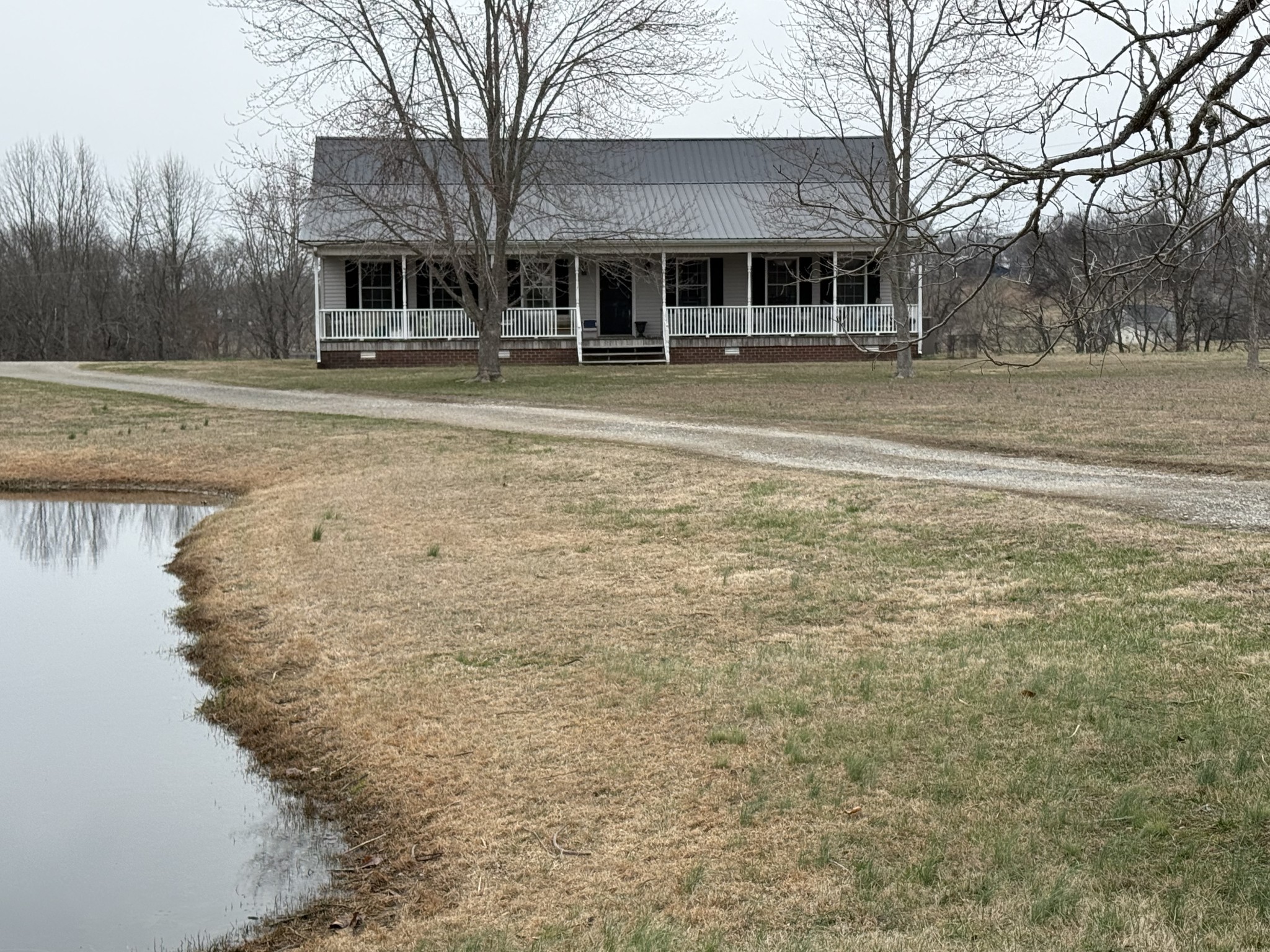 a front view of residential houses with yard and trees