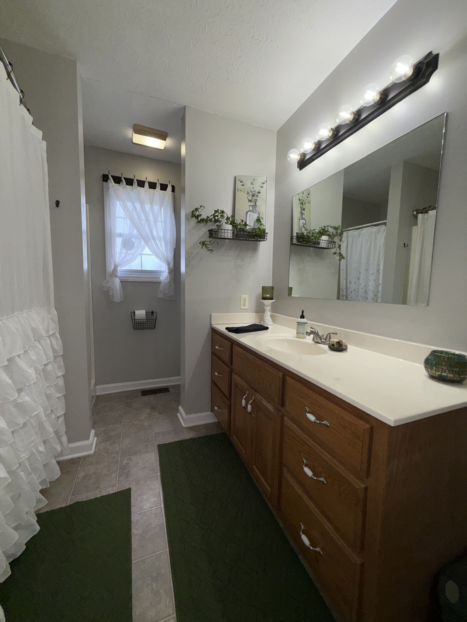 144 B Leo Carter Road Bethpage, TN 37022 - Photo 15 of 34 a bathroom with a double vanity sink and mirror