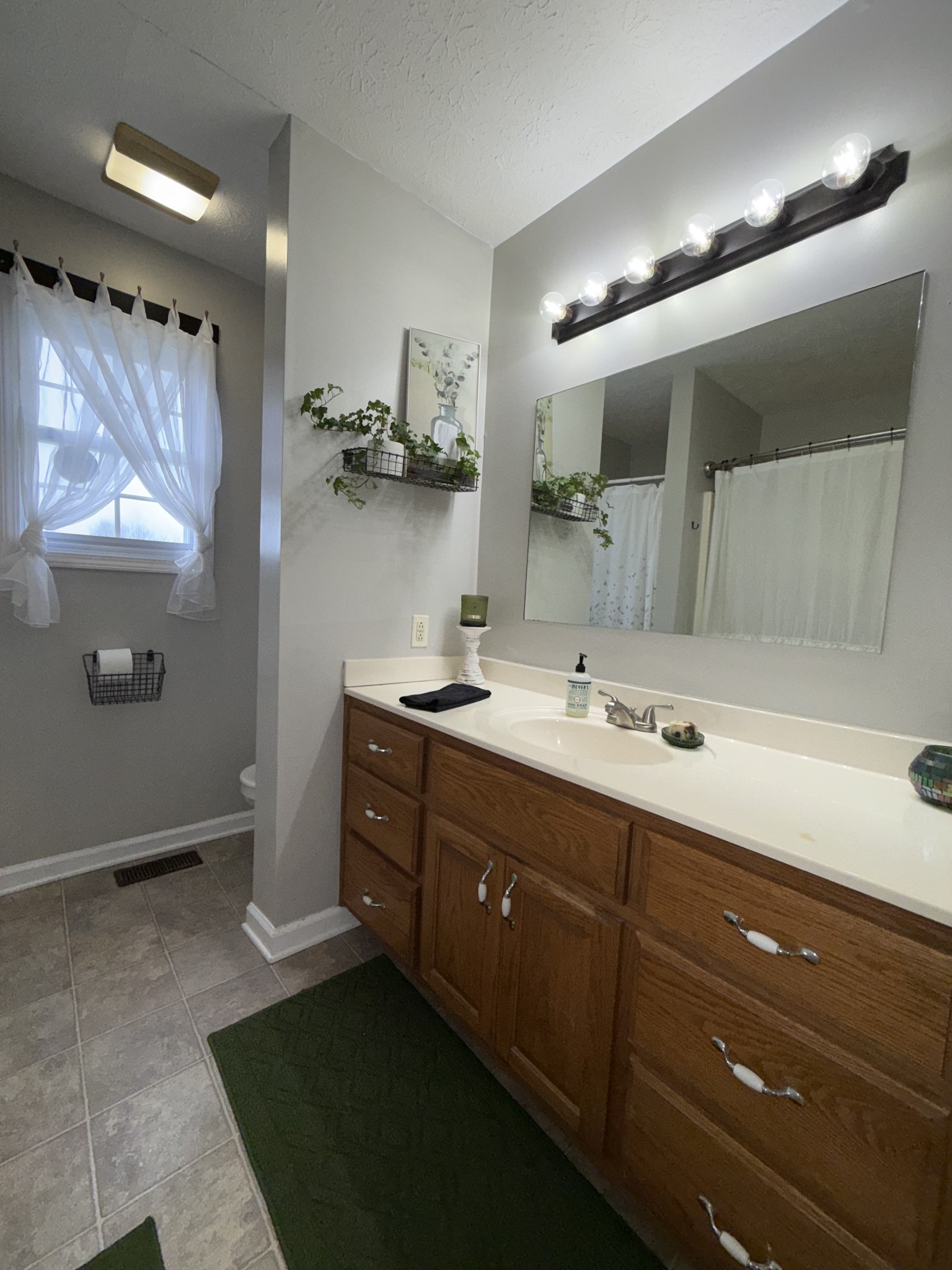 144 B Leo Carter Road Bethpage, TN 37022 - Photo 16 of 34 a bathroom with a double vanity sink and a mirror