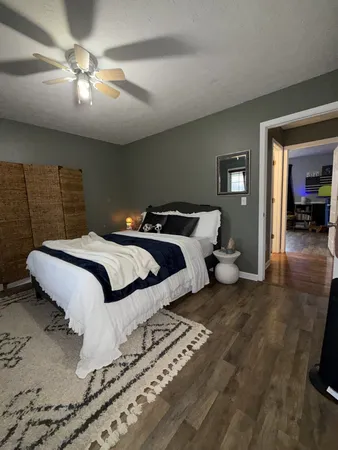 a bedroom with a bed and a chandelier