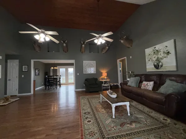 a living room with furniture a chandelier and a fireplace
