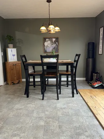 a dining room with furniture and window