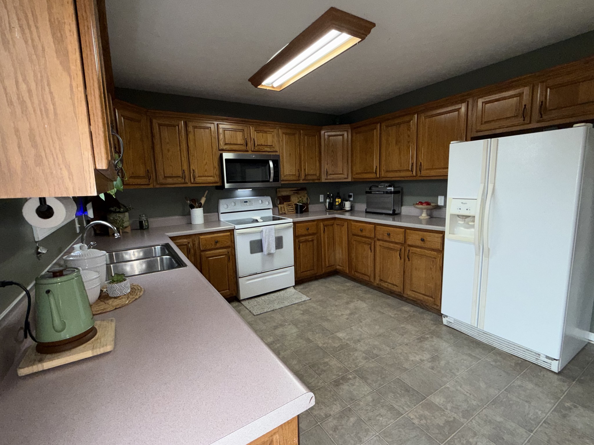 144 B Leo Carter Road Bethpage, TN 37022 - Photo 10 of 34 a kitchen with a sink a refrigerator and a stove top oven