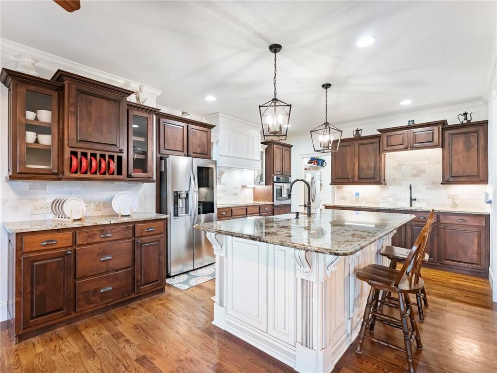 8629 Drake Drive Lula, GA 30554 - Photo 9 of 78 a kitchen with stainless steel appliances granite countertop a sink a stove and a wooden floors