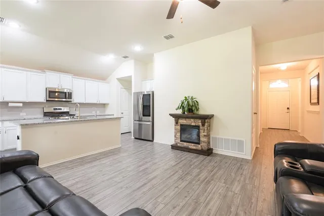 a living room with furniture and a fireplace