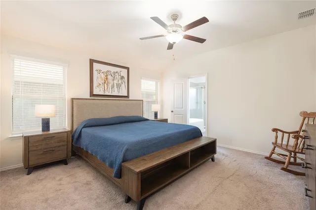 a bedroom with a bed and a ceiling fan