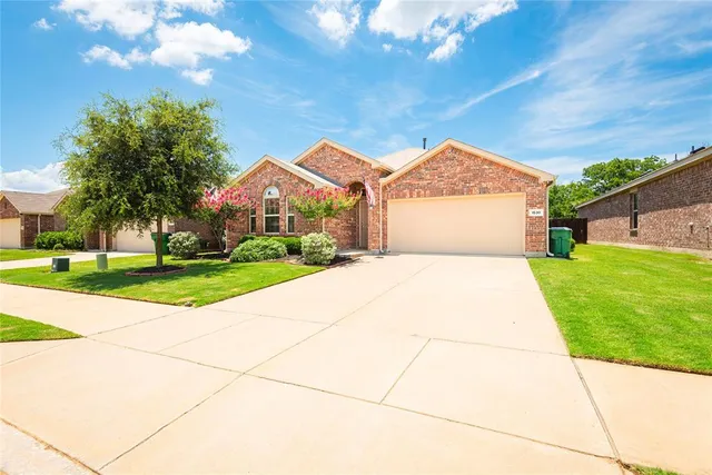 a kitchen with stainless steel appliances granite countertop a refrigerator a stove top oven a sink and dishwasher