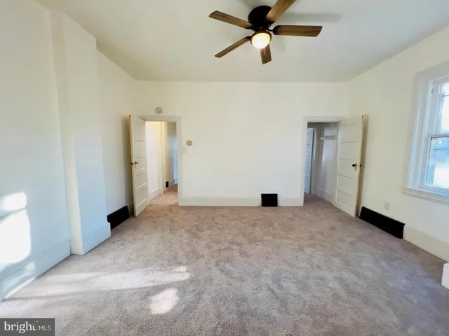 a view of a big room with closet and windows