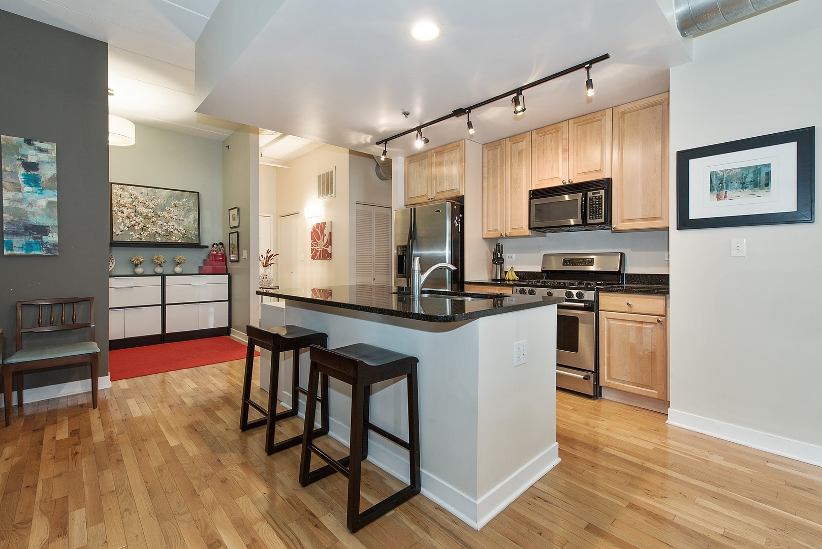 920 West Madison Street, Unit 6C Chicago, IL 60607 - Photo 2 of 10 a kitchen with stainless steel appliances a stove a sink a microwave a refrigerator and cabinets