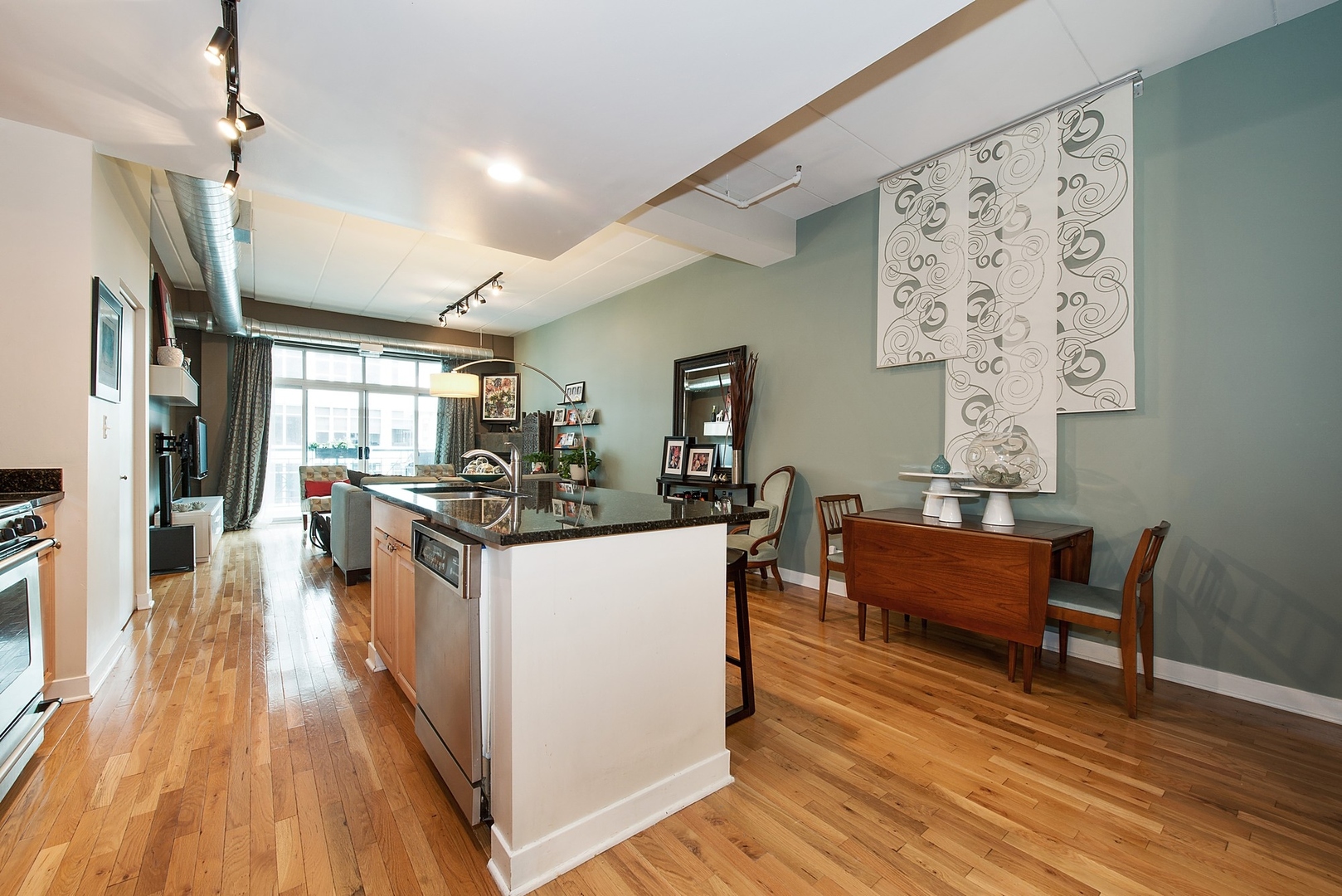 920 West Madison Street, Unit 6C Chicago, IL 60607 - Photo 4 of 10 a living room with furniture and wooden floor