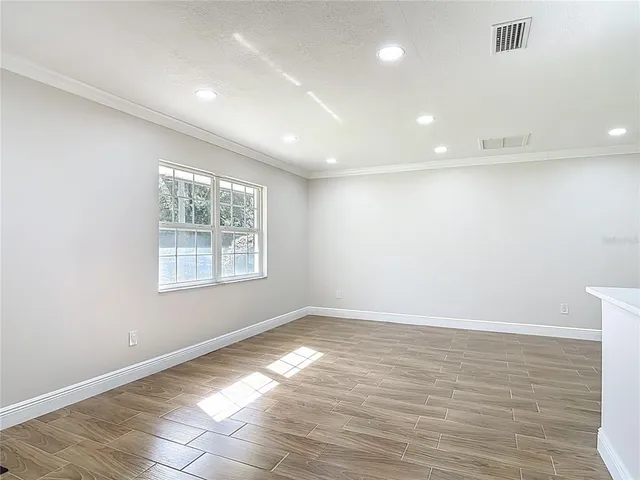 an aerial view of residential houses with outdoor space and trees