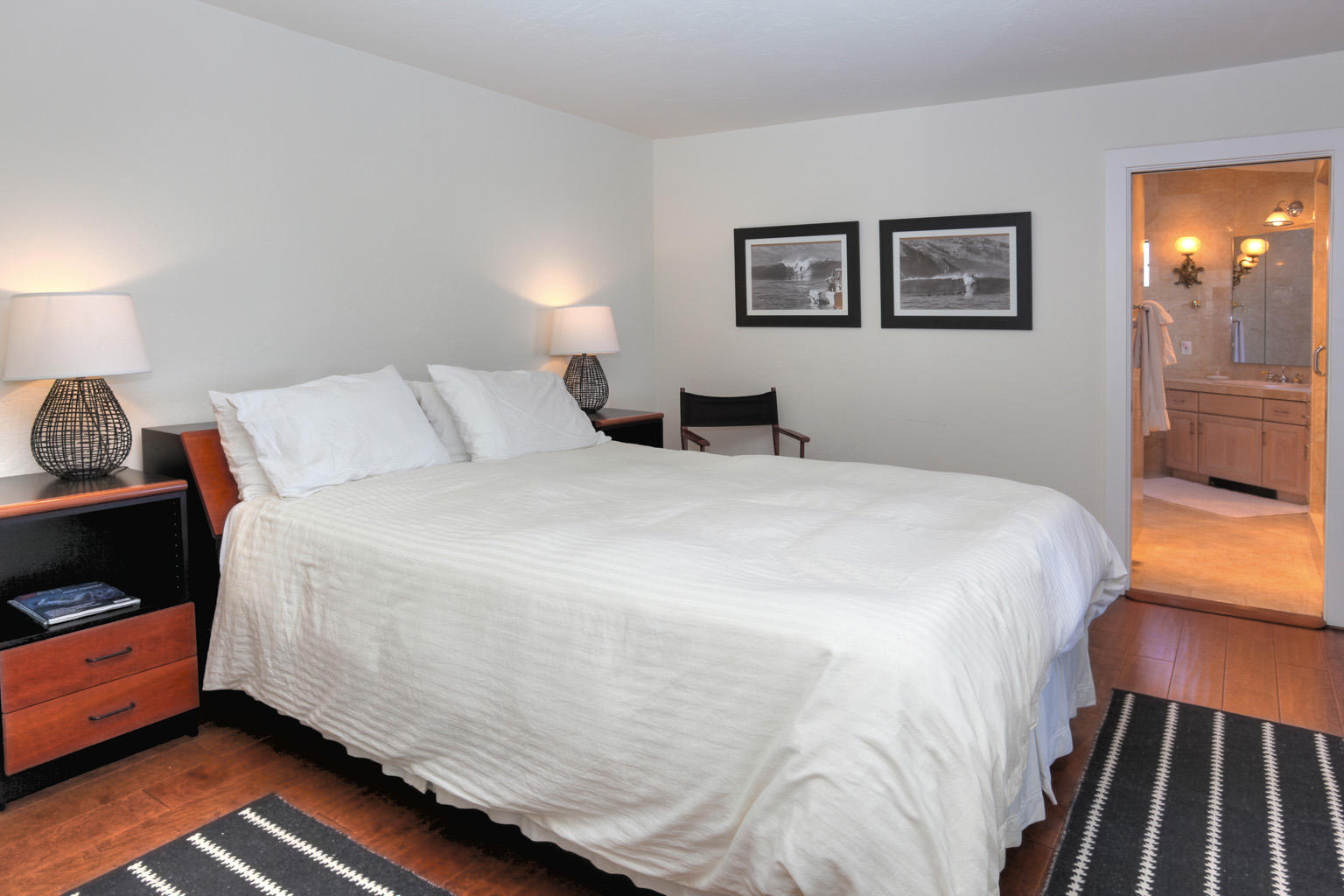 393 Las Alturas Road Santa Barbara, CA 93103 - Photo 13 of 17 a large bed sitting in a bedroom next to a lamp