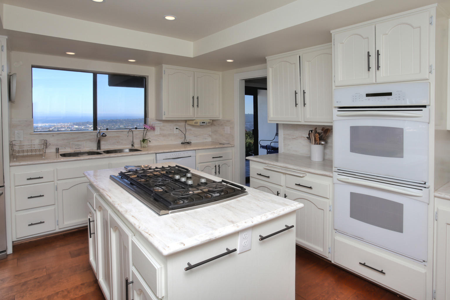 393 Las Alturas Road Santa Barbara, CA 93103 - Photo 14 of 17 a kitchen with white cabinets and appliances