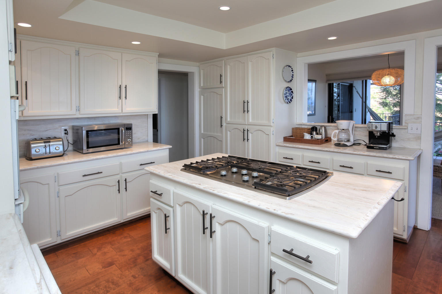 393 Las Alturas Road Santa Barbara, CA 93103 - Photo 15 of 17 a kitchen with white cabinets and appliances