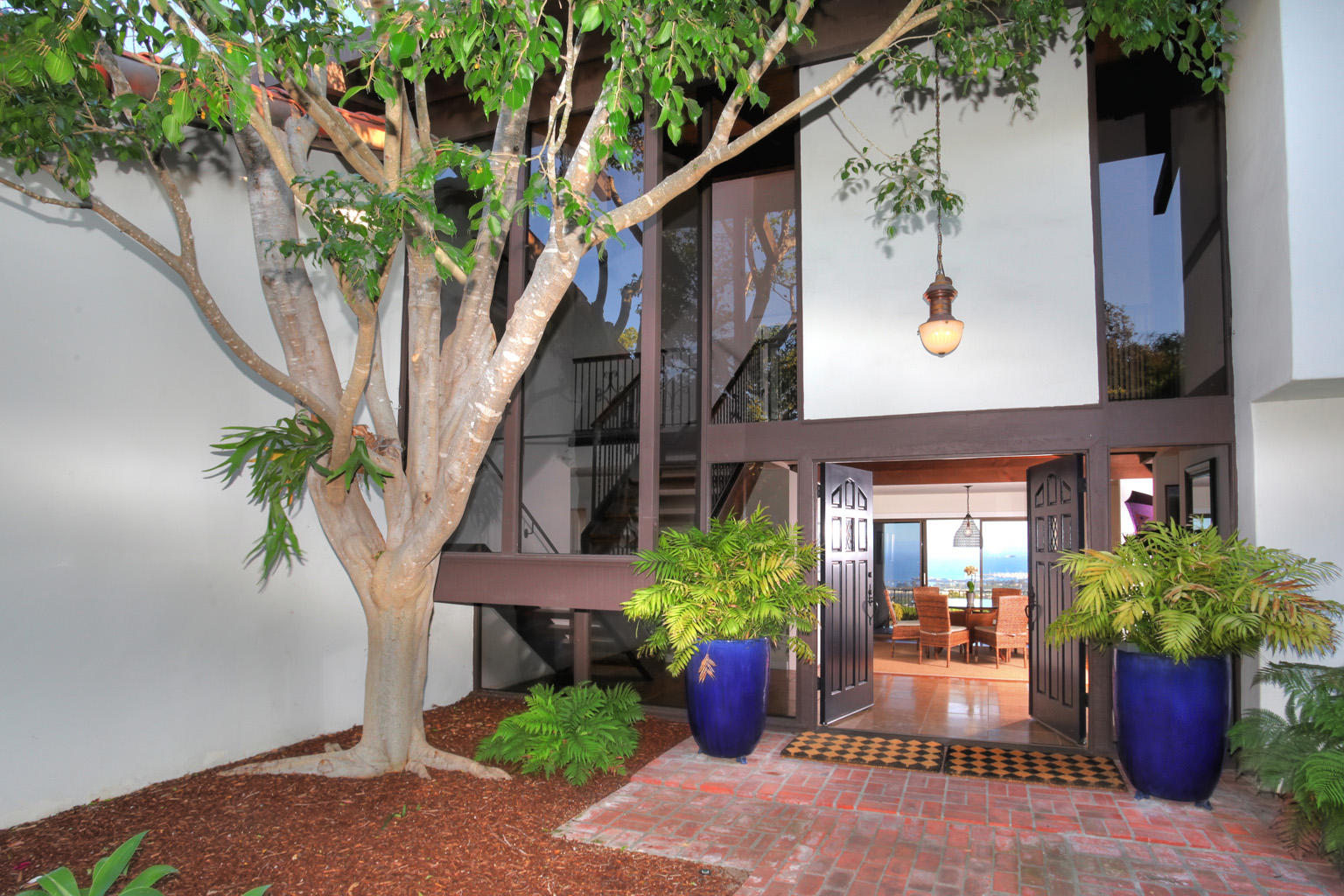 393 Las Alturas Road Santa Barbara, CA 93103 - Photo 2 of 17 a potted plant sitting in front of a house