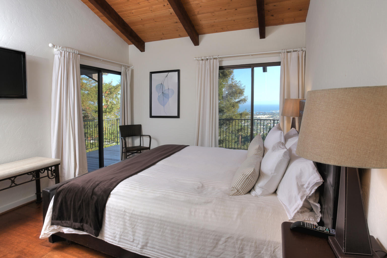 393 Las Alturas Road Santa Barbara, CA 93103 - Photo 9 of 17 a bedroom with a bed and a flat tv screen on the dresser