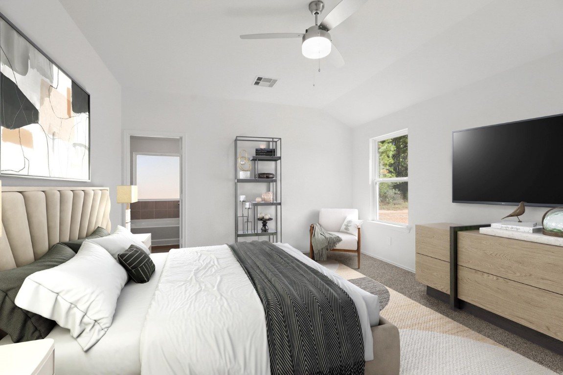 501 Comal Trail Dayton, TX 77535 - Photo 5 of 14 a bedroom with a bed and a flat screen tv on the dresser