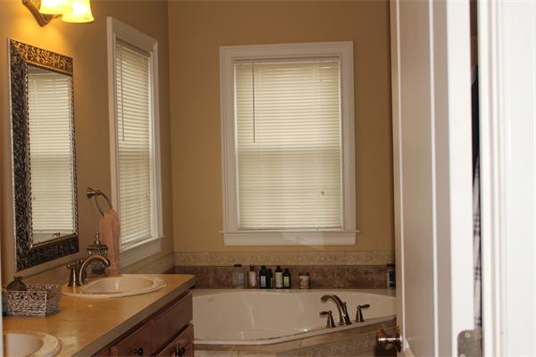 8 Button Road Easthampton, MA 01027 - Photo 7 of 10 a bathroom with a granite countertop sink a mirror and a bathtub