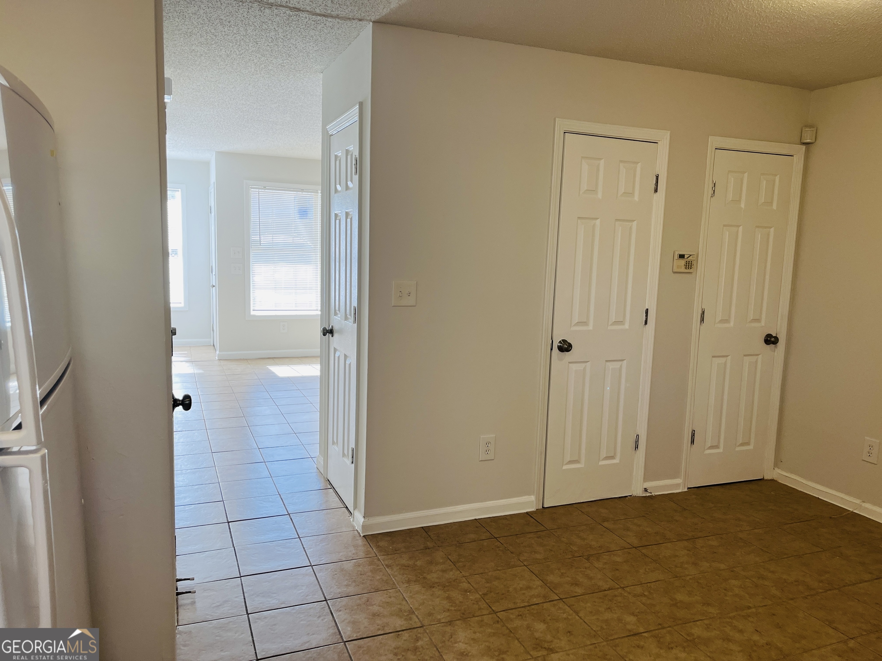 1701 Hunting Creek Lane Southeast, Unit 1701 Conyers, GA 30013 - Photo 11 of 20 a view of an empty room with wooden door