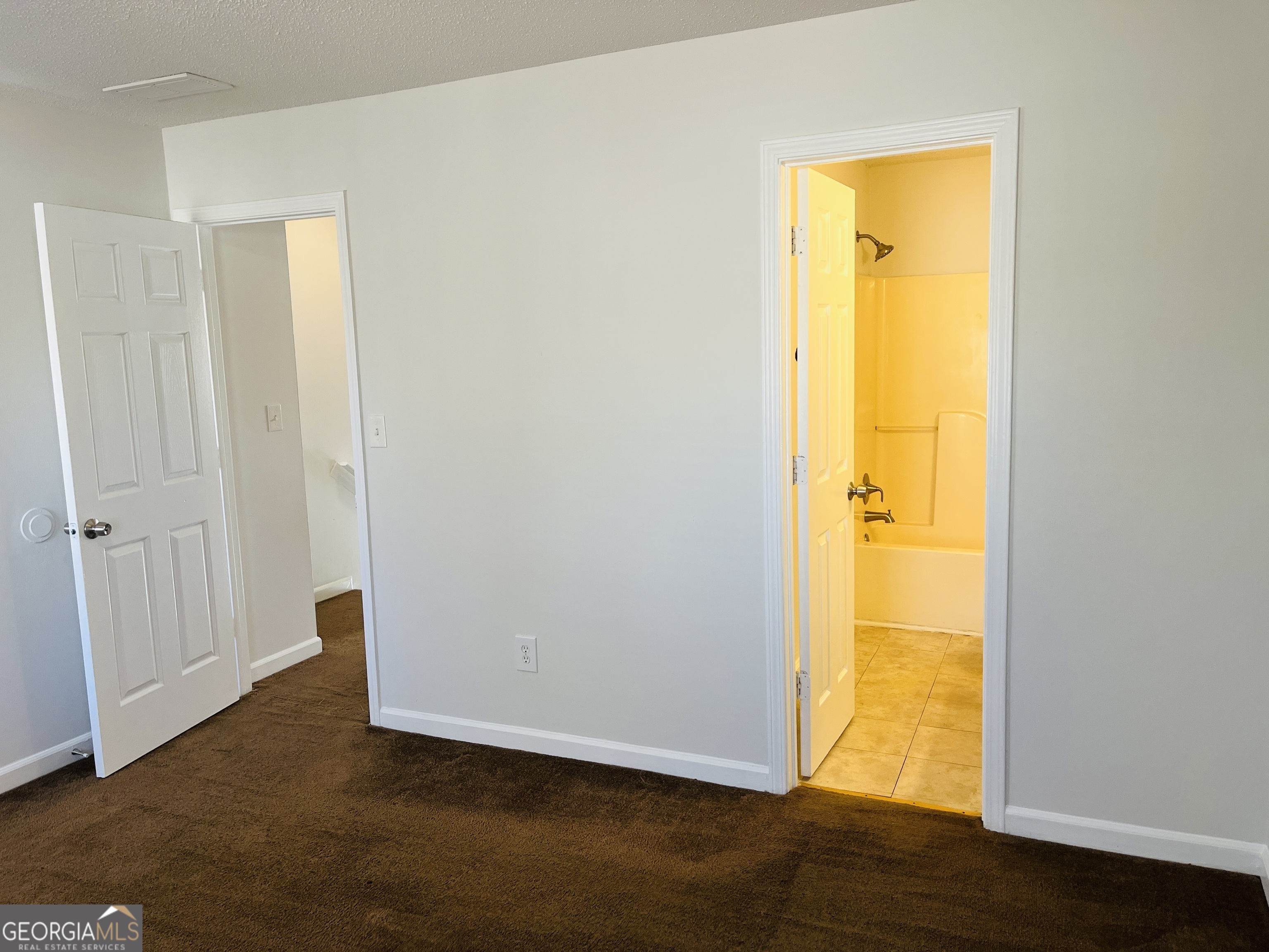 1701 Hunting Creek Lane Southeast, Unit 1701 Conyers, GA 30013 - Photo 17 of 20 a view of a room with a bed and wooden floor