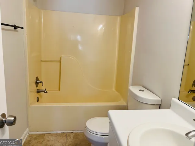 a bathroom with a toilet and a bathtub