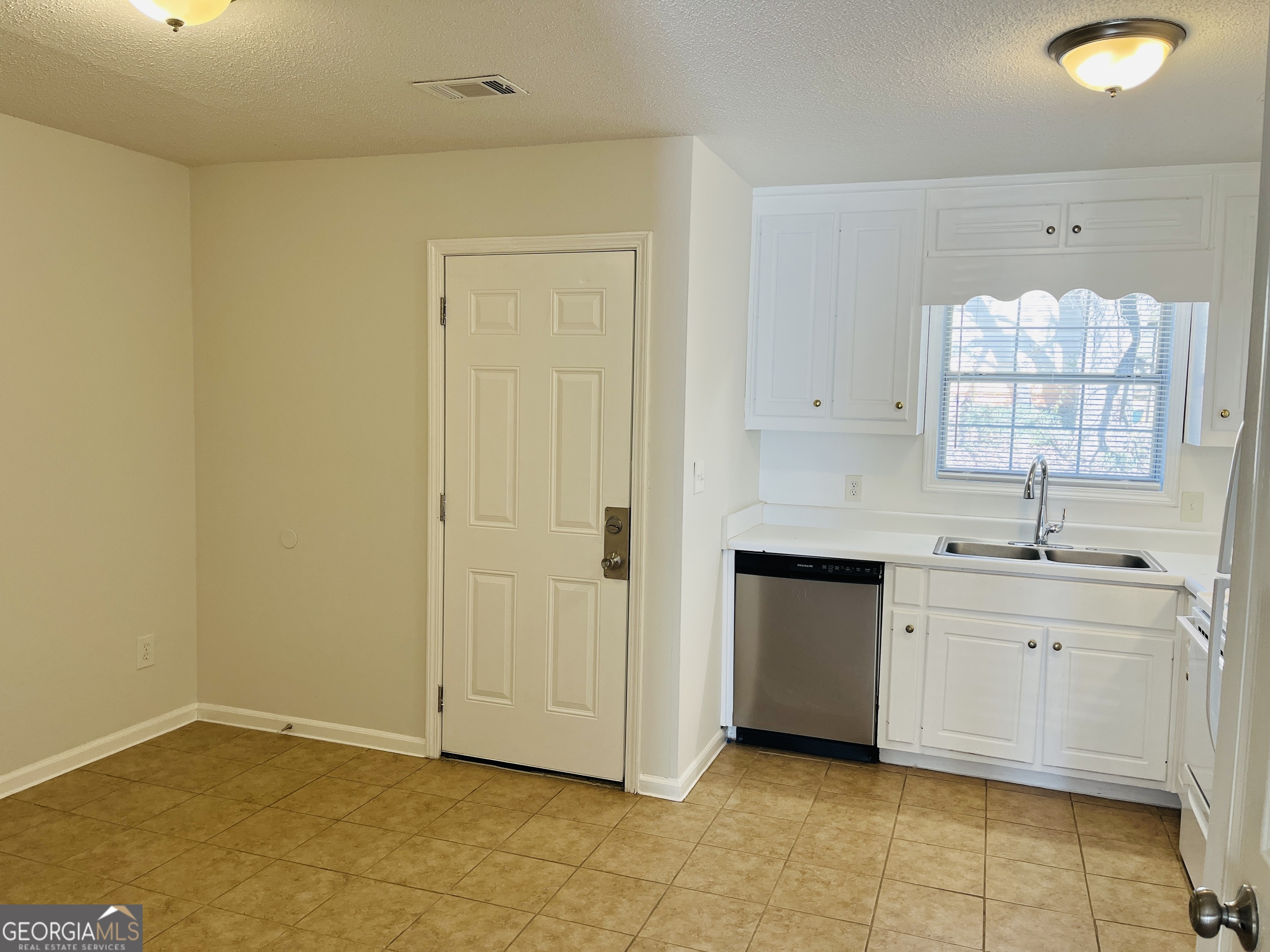 1701 Hunting Creek Lane Southeast, Unit 1701 Conyers, GA 30013 - Photo 7 of 20 a view of a kitchen with white cabinets