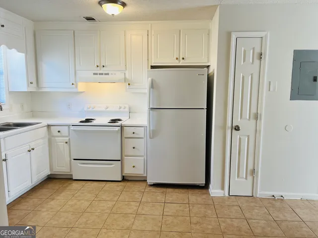 a kitchen with cabinets stainless steel appliances and a counter space