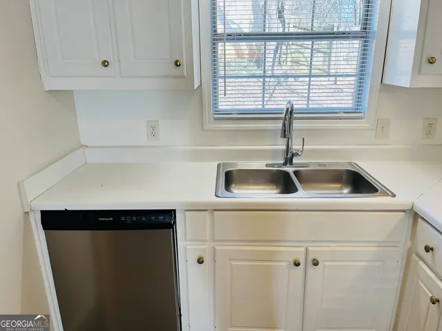 a kitchen with a sink and cabinets